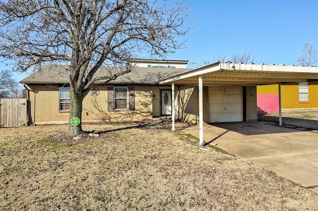 ranch-style house with fence, concrete driveway, a garage, a carport, and brick siding