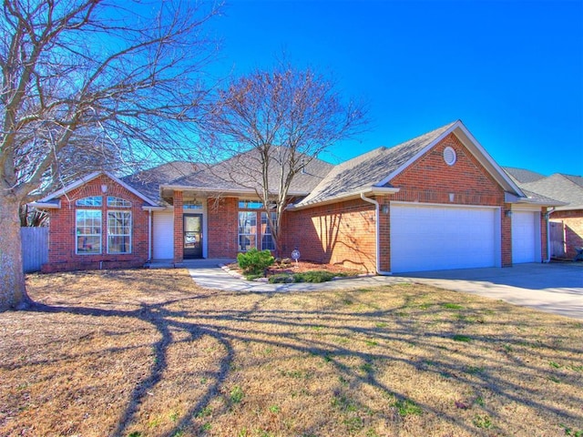 ranch-style home with driveway, a front lawn, fence, an attached garage, and brick siding