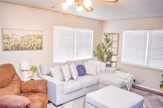 living room with baseboards, a wealth of natural light, and ceiling fan