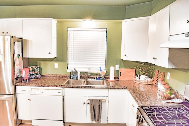 kitchen featuring under cabinet range hood, white cabinets, appliances with stainless steel finishes, and a sink