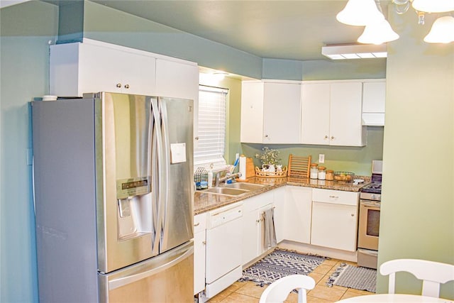 kitchen with custom range hood, a sink, white cabinetry, stainless steel appliances, and light tile patterned floors