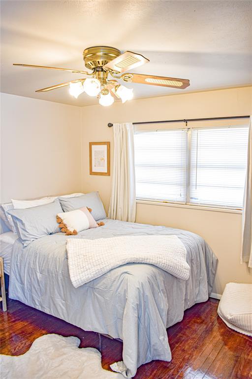 bedroom featuring hardwood / wood-style floors and a ceiling fan