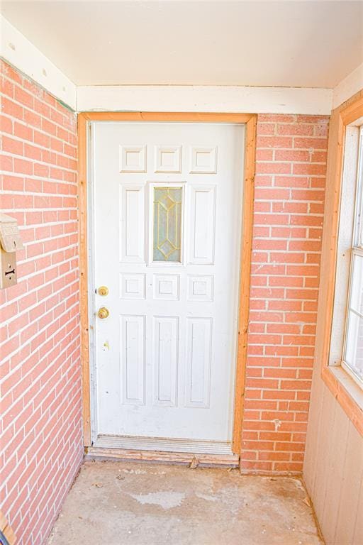 view of exterior entry with brick siding