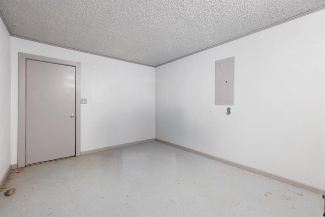 spare room with electric panel, a textured ceiling, concrete flooring, and baseboards