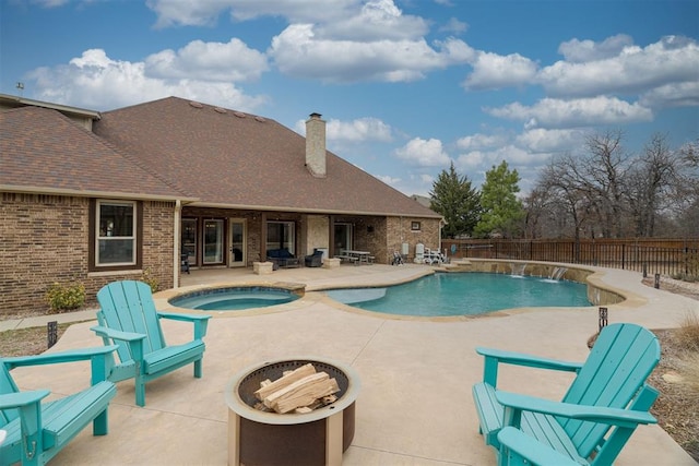 view of swimming pool featuring an in ground hot tub, a fenced in pool, a fenced backyard, and a patio