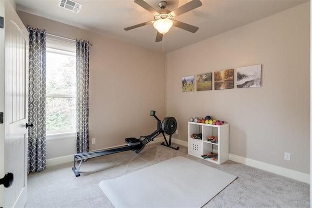 exercise area featuring visible vents, baseboards, ceiling fan, and carpet flooring