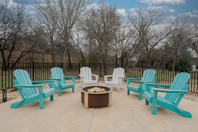 view of patio with a fire pit and fence