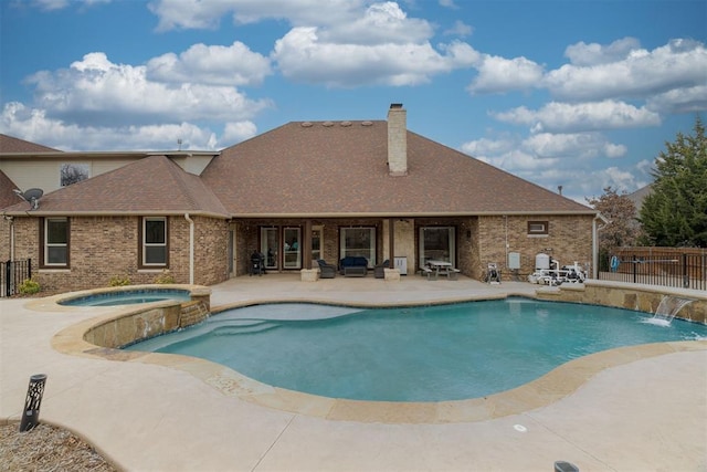 view of swimming pool featuring a patio, a pool with connected hot tub, and fence