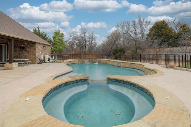 view of pool with a patio, a fenced backyard, and a pool with connected hot tub