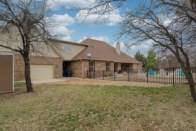 view of front of house featuring a front yard, fence, brick siding, and a chimney