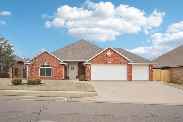 view of front of home featuring fence, concrete driveway, an attached garage, a shingled roof, and brick siding