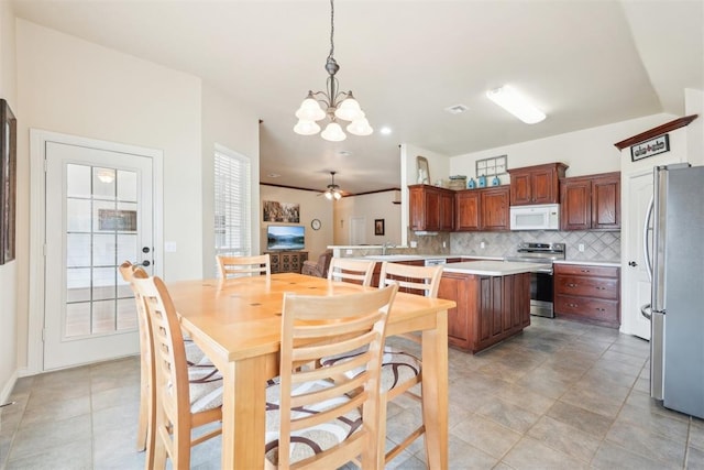 dining space with ceiling fan with notable chandelier and visible vents