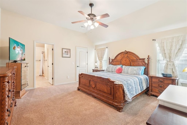 bedroom featuring visible vents, light carpet, ensuite bath, baseboards, and vaulted ceiling