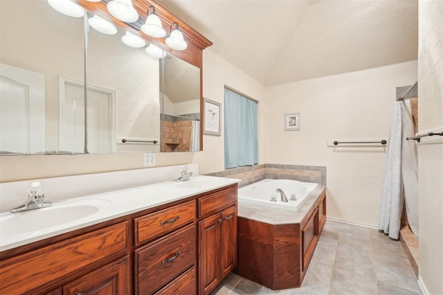 bathroom featuring a sink, lofted ceiling, a garden tub, and tile patterned flooring