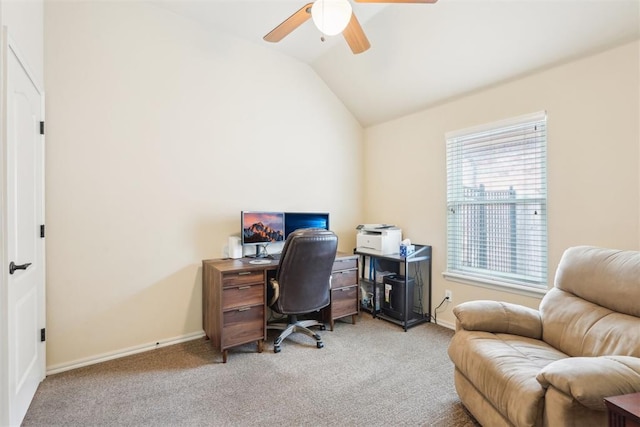 carpeted home office with baseboards, ceiling fan, and vaulted ceiling