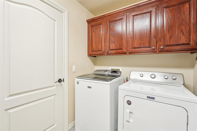 washroom with cabinet space and washer and dryer