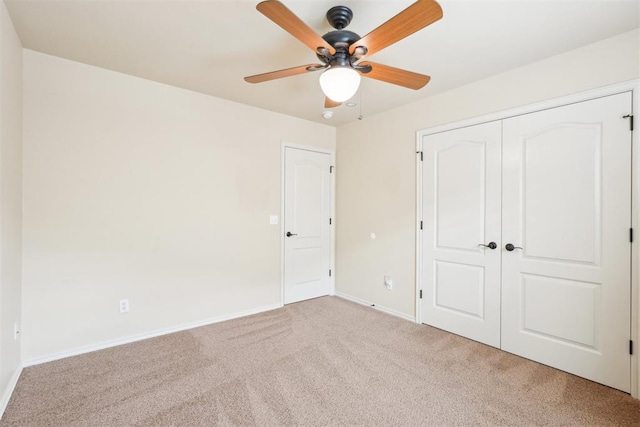 unfurnished bedroom featuring a closet, ceiling fan, baseboards, and carpet floors