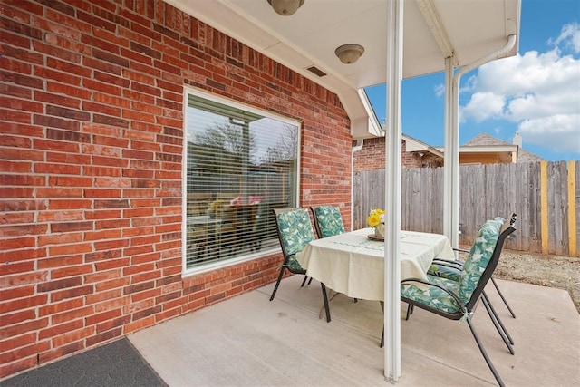 view of patio / terrace featuring outdoor dining area and fence