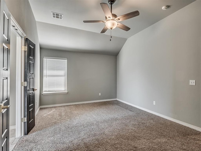 empty room featuring visible vents, baseboards, ceiling fan, light colored carpet, and lofted ceiling