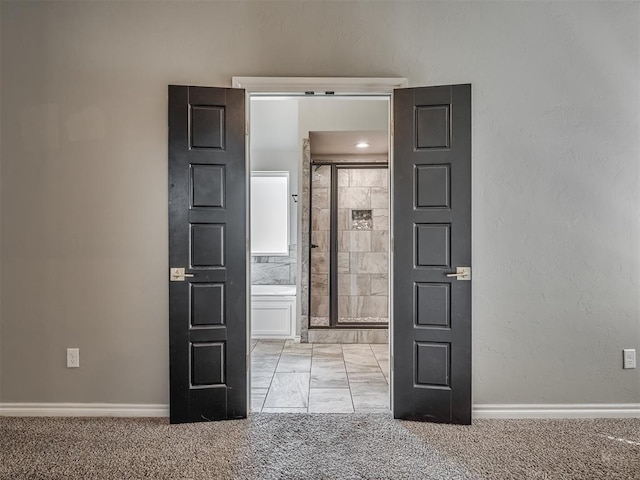 spare room with light carpet and baseboards