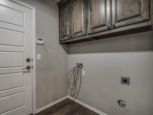 washroom with baseboards, hookup for a washing machine, cabinet space, hookup for an electric dryer, and dark wood-style flooring