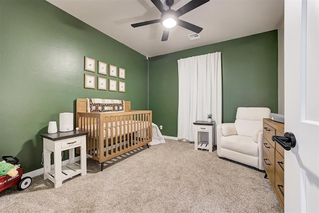 2580 Sunset Ct, Guthrie, OK 73044 - carpeted bedroom with a nursery area and a ceiling fan