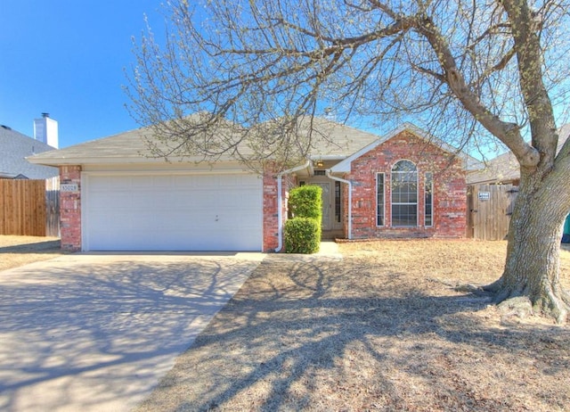 ranch-style home with concrete driveway, an attached garage, fence, and brick siding