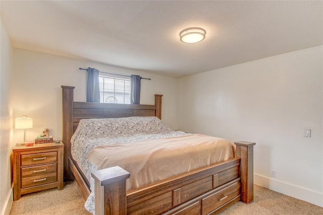 bedroom featuring baseboards and light carpet