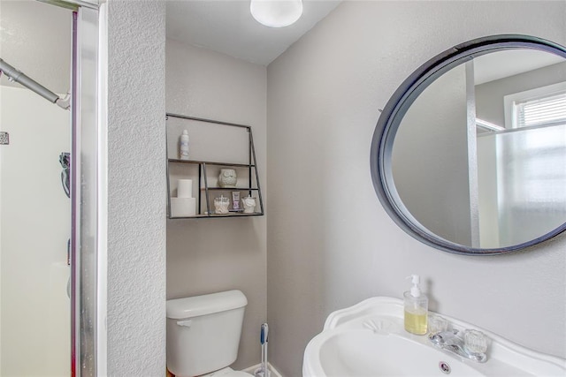 bathroom with toilet and a sink