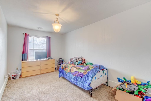 carpeted bedroom with visible vents and baseboards