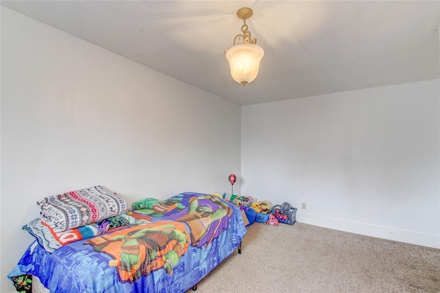 carpeted bedroom featuring baseboards