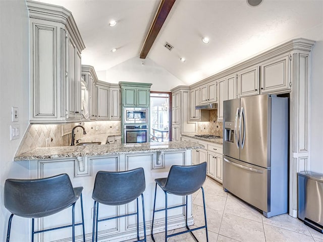 kitchen featuring visible vents, under cabinet range hood, stainless steel appliances, a peninsula, and light stone countertops