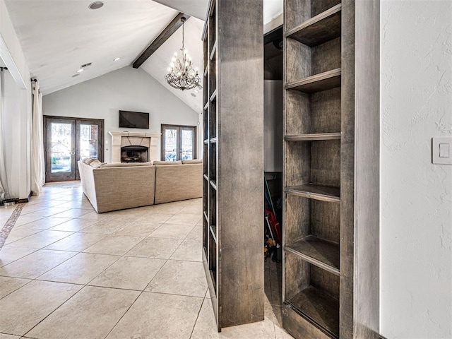 interior space with a wealth of natural light, vaulted ceiling with beams, a fireplace, and tile patterned flooring