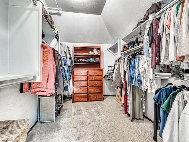 spacious closet with vaulted ceiling and carpet floors