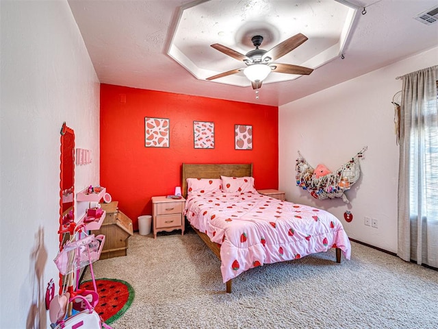 carpeted bedroom with visible vents and ceiling fan