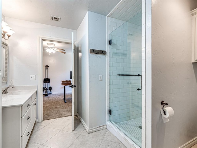 full bathroom with tile patterned floors, visible vents, a shower stall, baseboards, and vanity