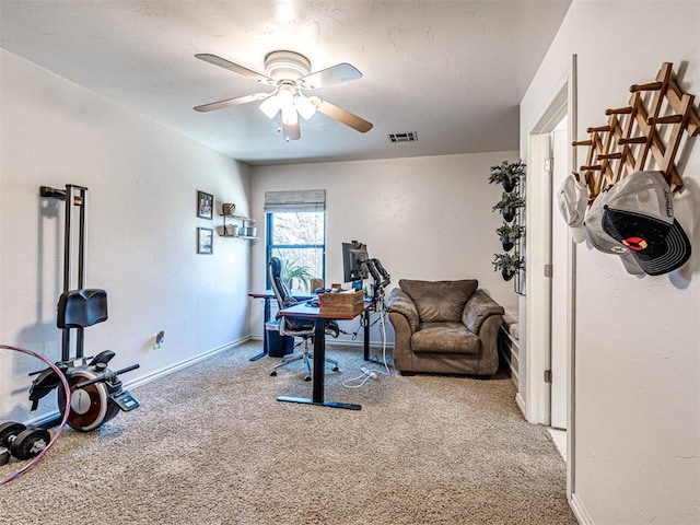 exercise area featuring visible vents, baseboards, carpet, and ceiling fan