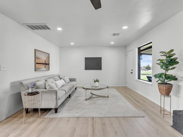 living room featuring visible vents, recessed lighting, and wood finished floors