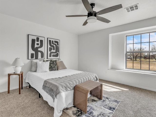 bedroom with baseboards, visible vents, carpet floors, and ceiling fan