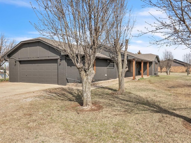 ranch-style house featuring roof with shingles, concrete driveway, a front yard, an attached garage, and brick siding