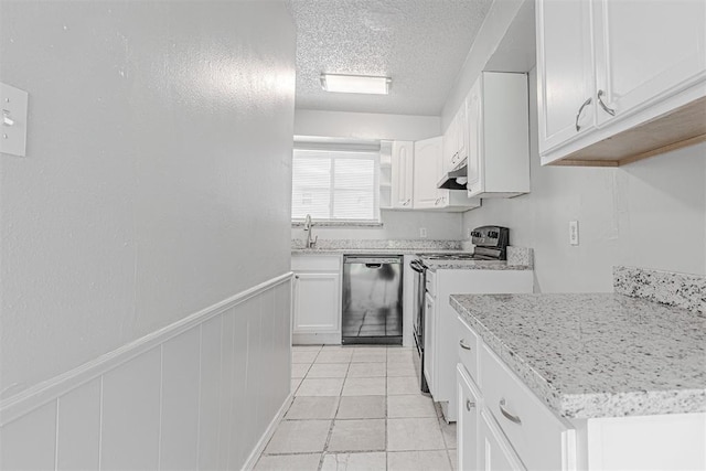 kitchen featuring a wainscoted wall, range with electric cooktop, under cabinet range hood, a textured ceiling, and dishwasher