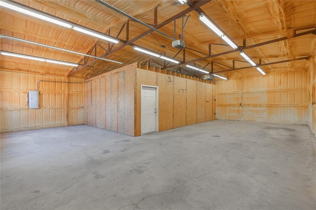 garage featuring electric panel and a garage door opener