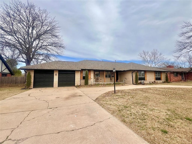 ranch-style house featuring brick siding, fence, a garage, and driveway