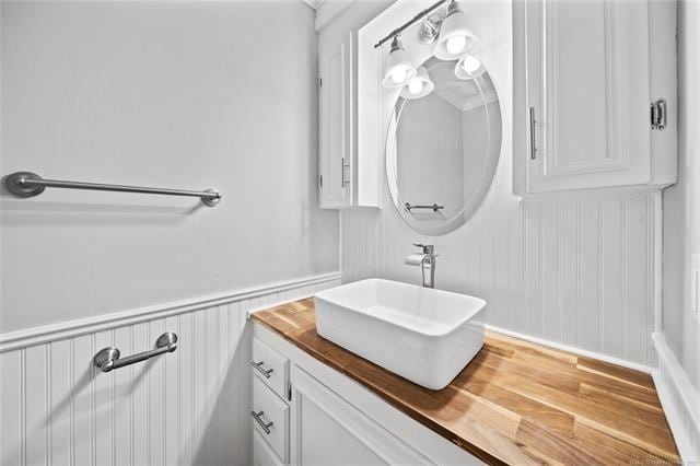 bathroom featuring vanity and a wainscoted wall