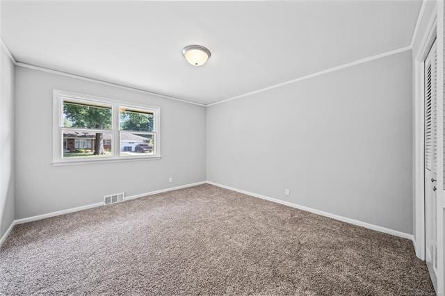 unfurnished bedroom with visible vents, carpet, a closet, and ornamental molding