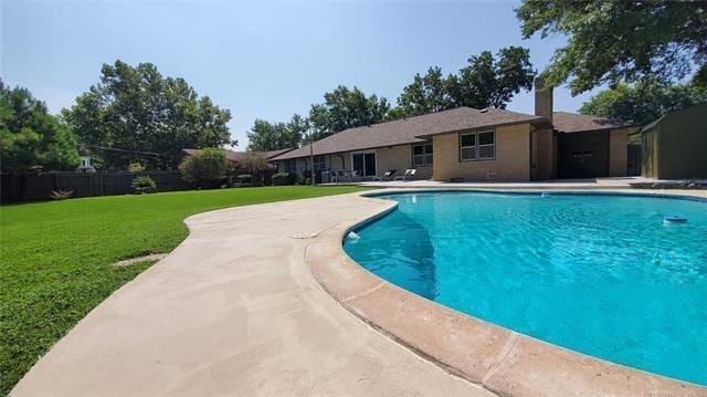 view of swimming pool featuring a fenced in pool and a yard