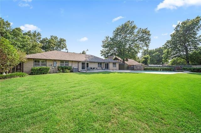 rear view of house with a yard