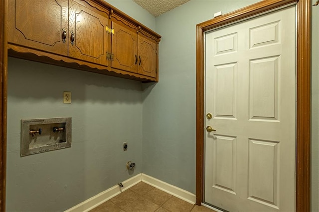 clothes washing area with baseboards, gas dryer hookup, hookup for a washing machine, cabinet space, and hookup for an electric dryer