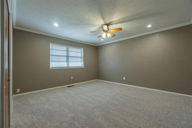 carpeted empty room featuring a ceiling fan, baseboards, and ornamental molding