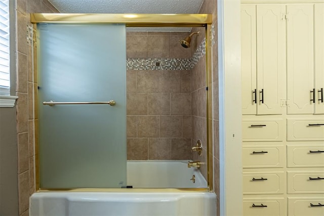 bathroom featuring a textured ceiling and washtub / shower combination